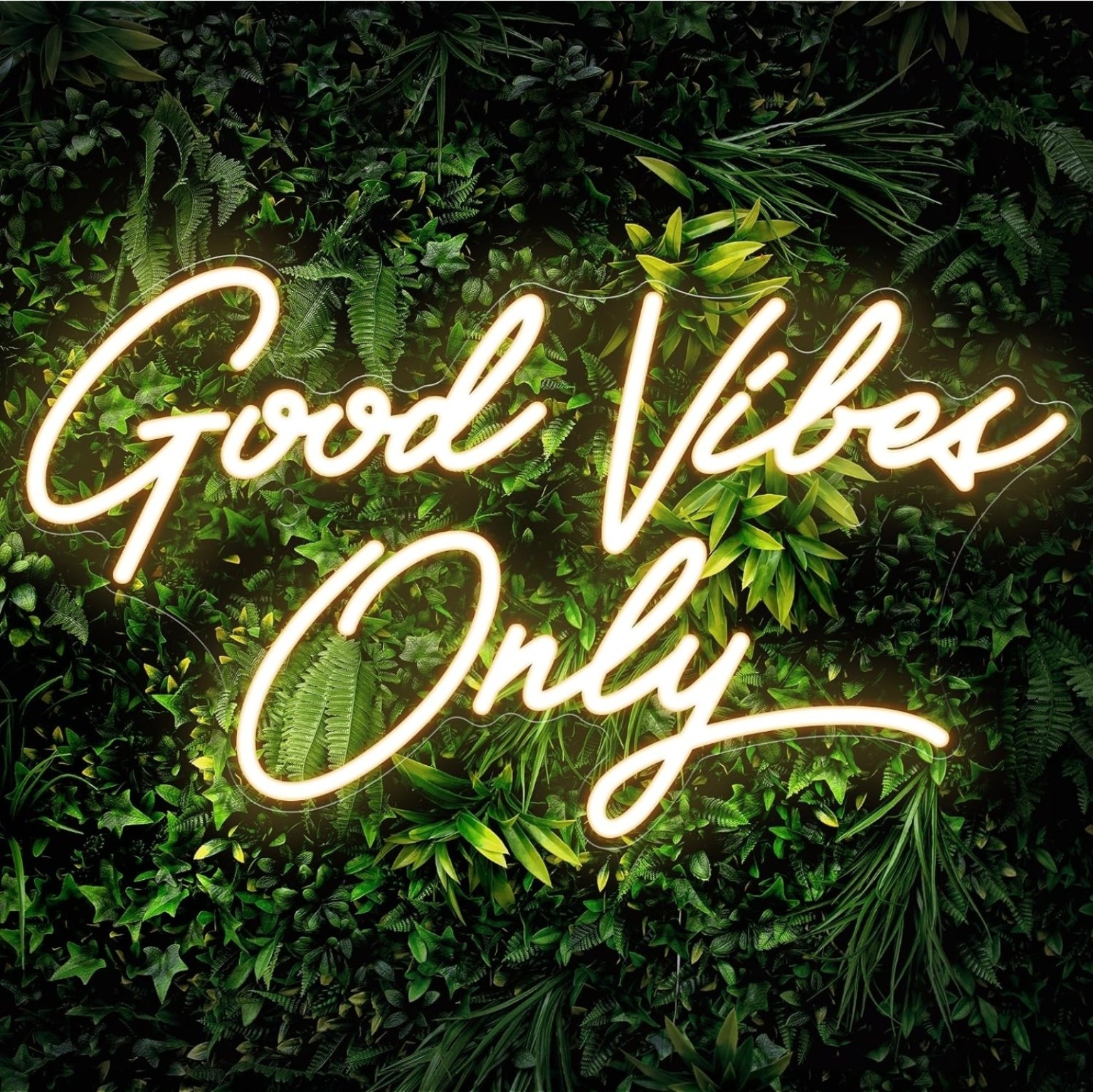 LED Good Vibes Only sign displayed on a greenery wall