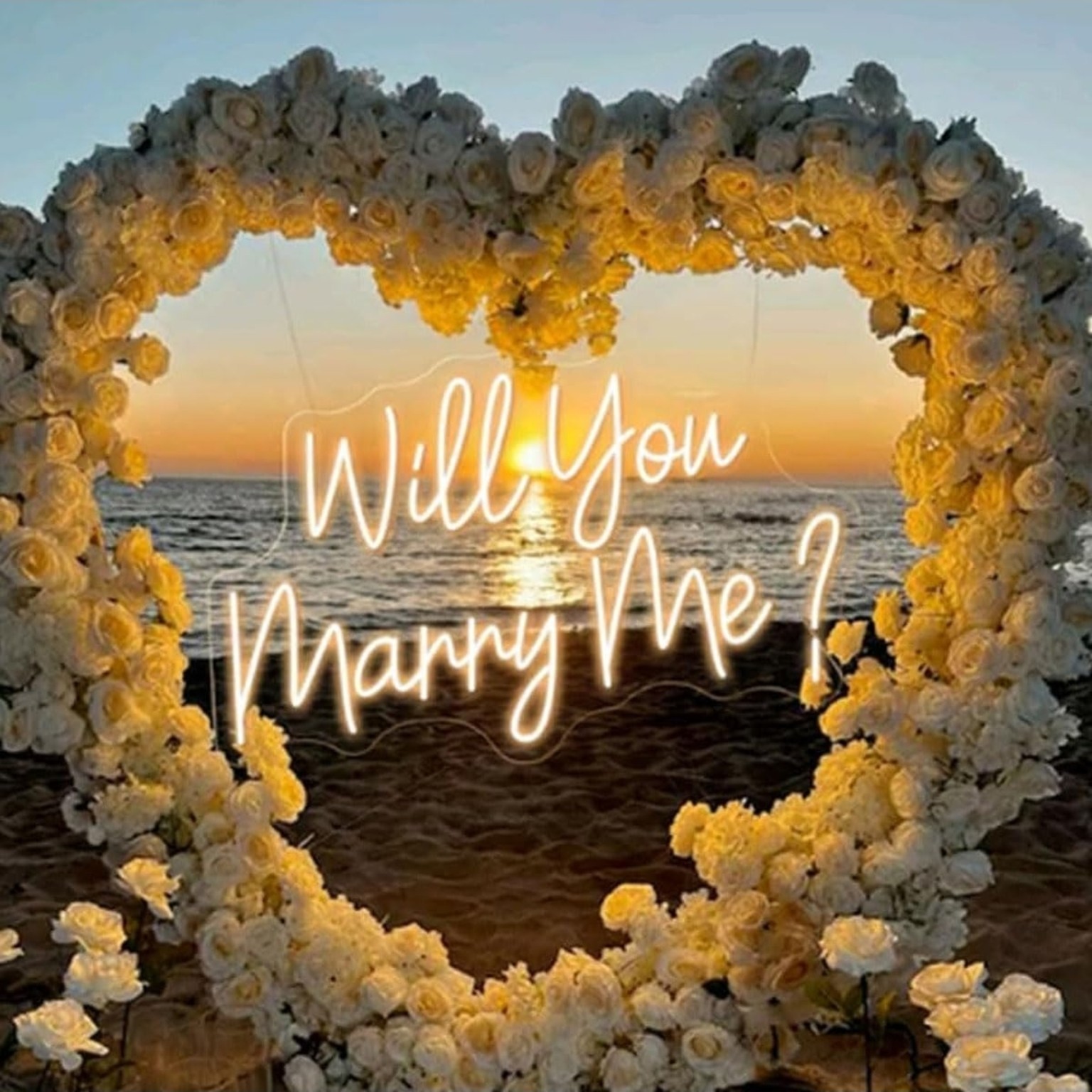LED Will You Marry Me sign displayed within a floral heart installation